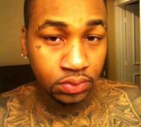 Ammar Harris police photo showing his many tattoos