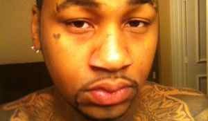 Ammar Harris police photo showing his many tattoos