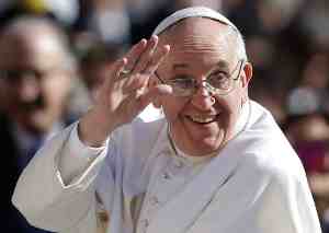 Pope Francis smiling and waving during his inauguration.